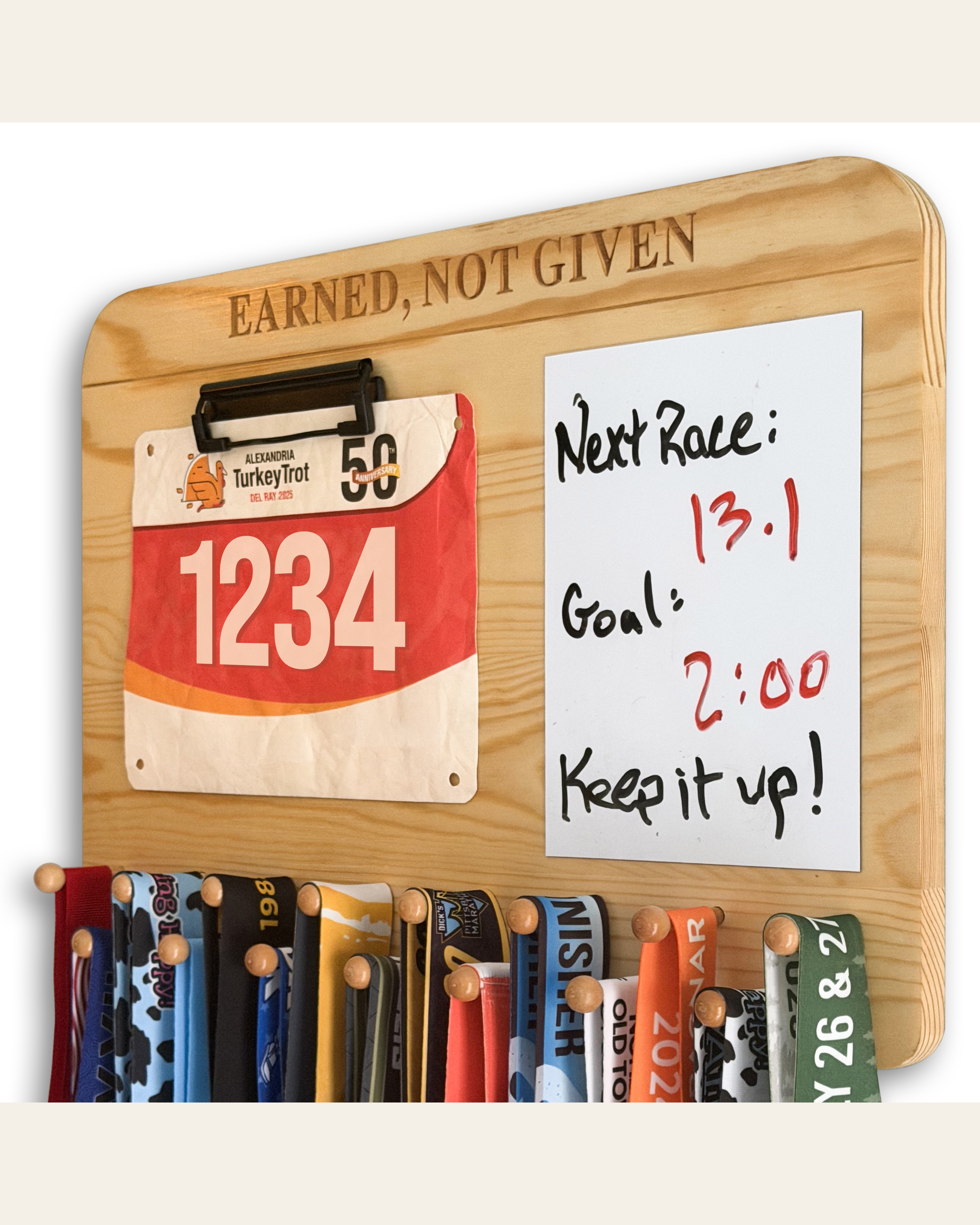 Solid pine medal hanger displaying race medals, a race bib, and a handwritten goal