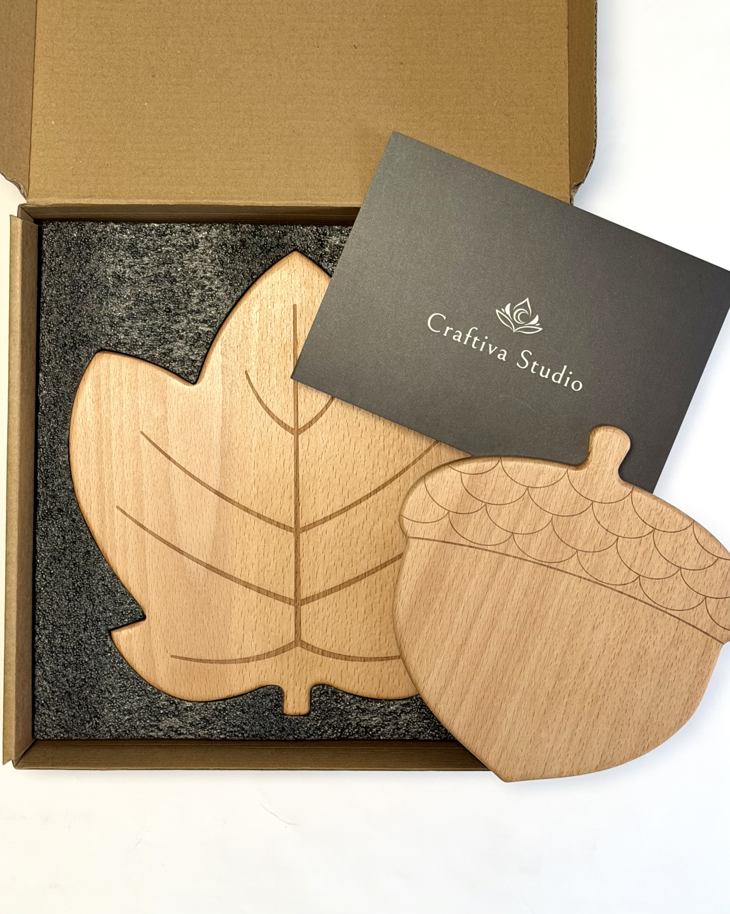 Open Craftiva trivet package with both trivets nested in foam and a printed card