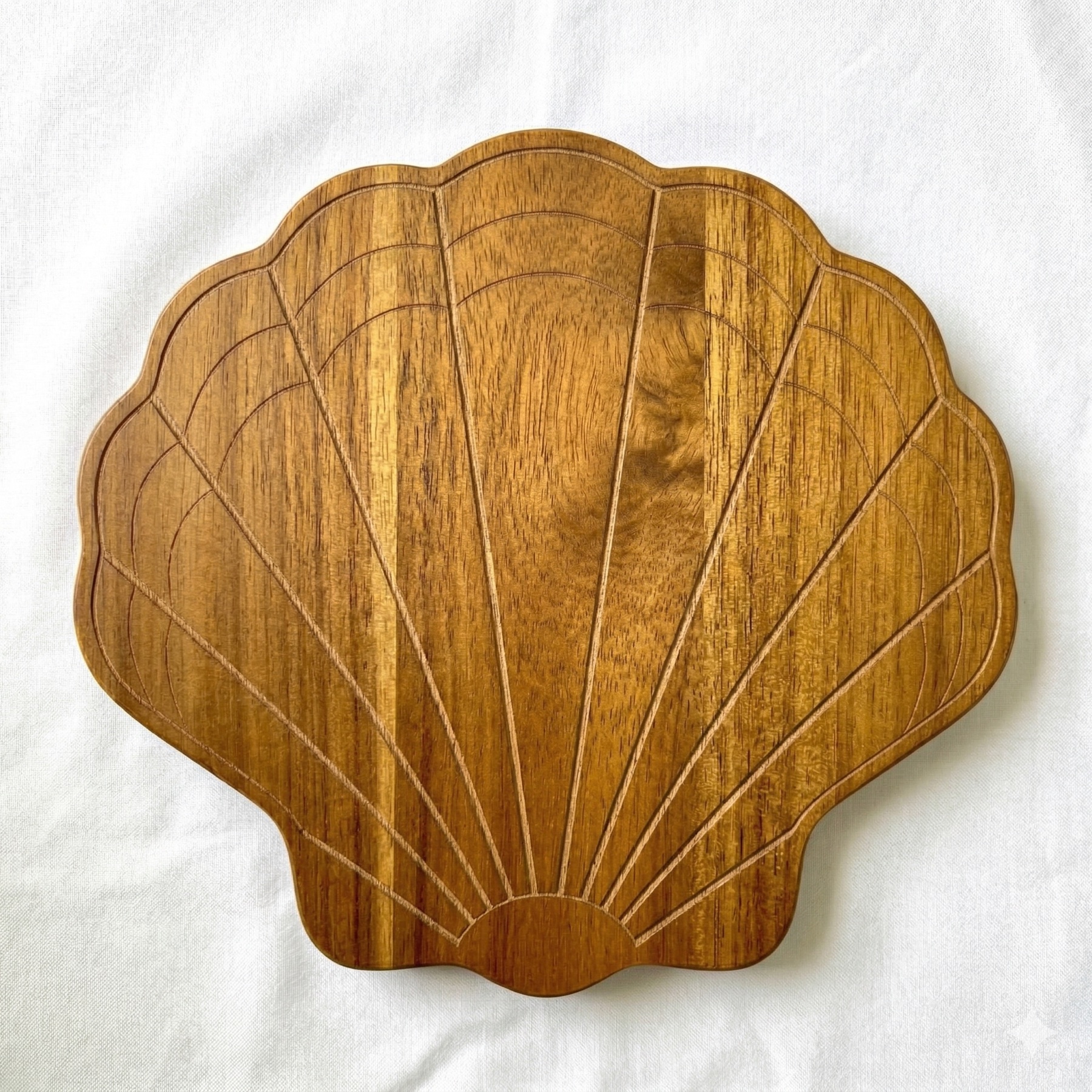 Shell-shaped carved wood trivet study